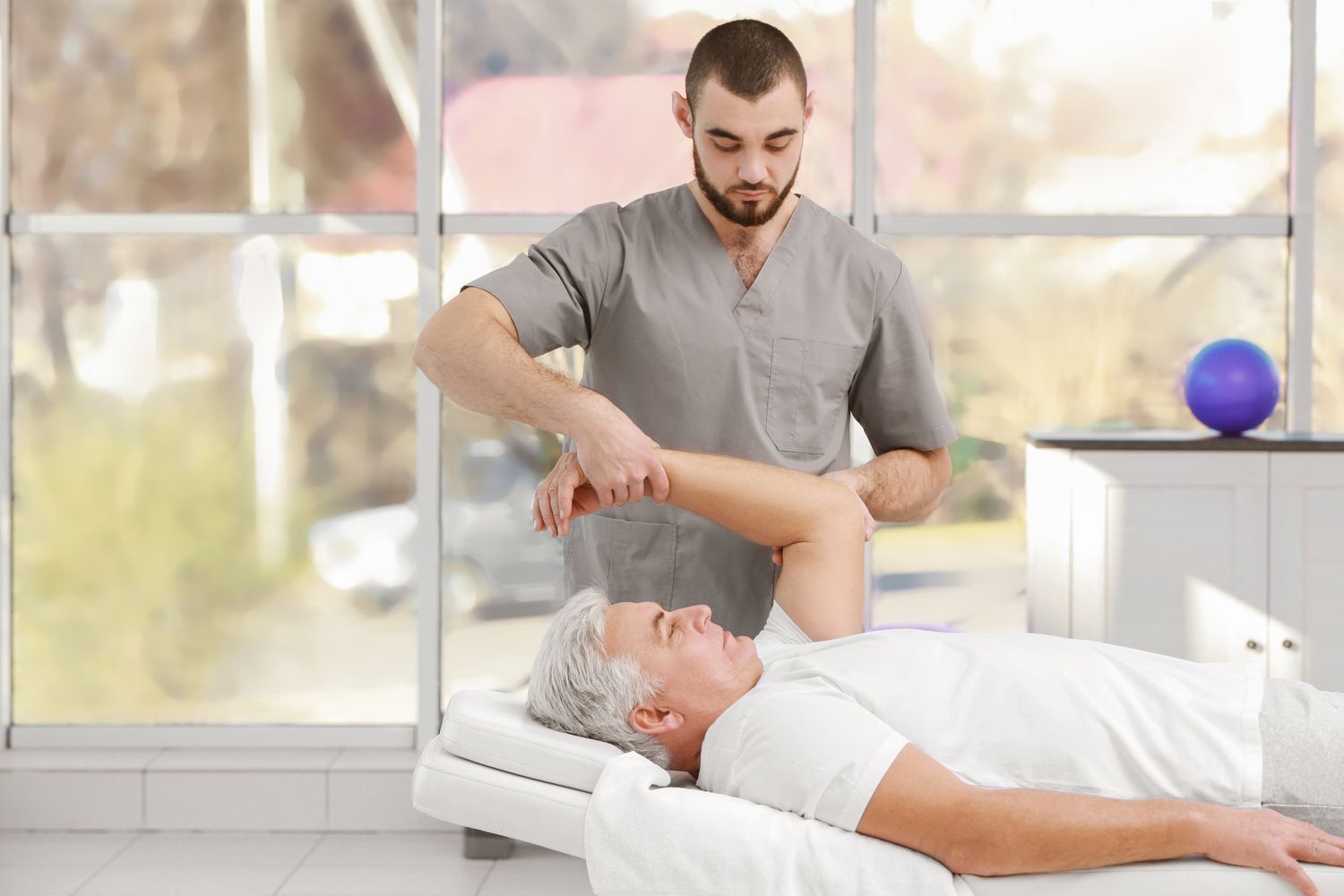 Physiotherapist working with patient in clinic